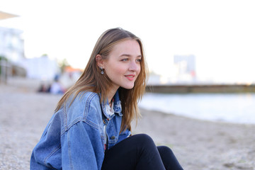 Portrait of cheerful girl who poses on camera and cute laughs si