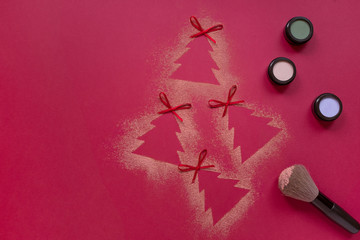 Christmas eyeshadows makeup flat lay, Christmas tree shaped crushed shadows on red background