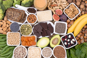 Magnesium food sources, top view on wooden background