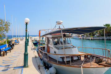 Fototapeta na wymiar Greek fishing boat is staying moored near pier on Rhodes island, Greece