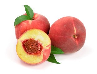 Peaches and half with green leaf isolated on white background