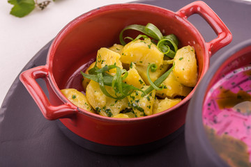 Boiled potato with small cut fennel, is served in a pig-iron pan