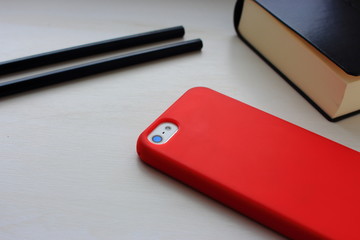 Business and office table desk with red phone and black pens (pencils) and leather notebook...