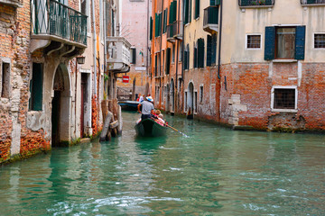 Fototapeta na wymiar Tourists ride on a gondola. VENICE, ITALY