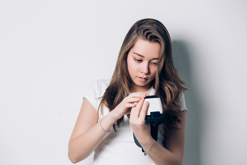 Naklejka premium Beautiful young girl holding a virtual reality headset