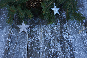 Christmas background. Christmas tree, pine cones, stars and snow over blue wood board. design mockup