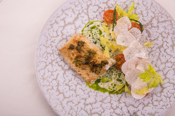 The sturgeon with capers, is served with leek, портобелло, a Savoy cabbage in creamy sauce