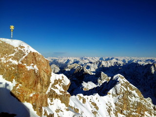 Zugspitze snow mountains with summit cross in Alps at winter, Germany