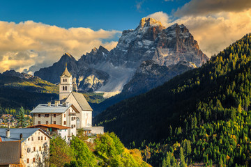 Fototapeta premium Amazing autumn landscape with church on the hill, Dolomites, Italy