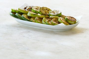 A plate with fried zucchini on a napkin