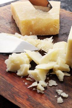 An aged authentic parmigiano reggiano parmesan cheese with cheese knife