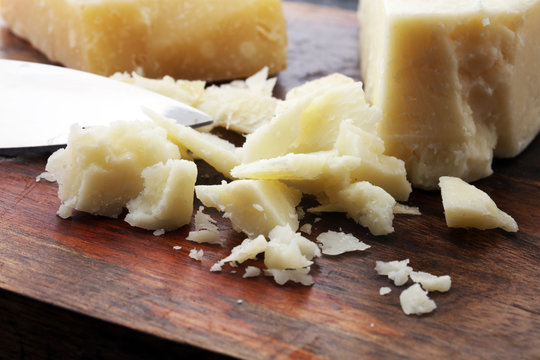 An aged authentic parmigiano reggiano parmesan cheese with cheese knife