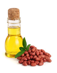 peanut oil in a glass bottle with peanuts