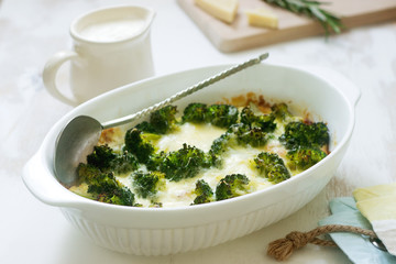 Casserole with broccoli, cauliflower and cheese on a light background.
