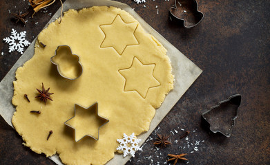 Christmas cookies background. Ginger dough for gingerbread, star, Christmas tree, spices (cinnamon,...
