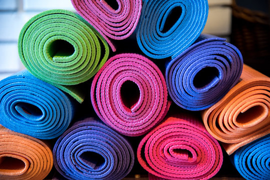 Pile of colorful yoga mats 