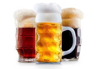 Mug collection of frosty dark red and light beer with foam isolated on a white background