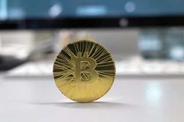 Golden bitcoin on a gray background