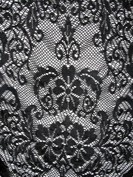 Black lace on white background.