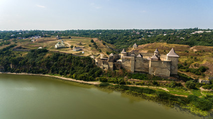 Fototapeta na wymiar Aerial view of Khotyn medieval castle on the green hill above the river.