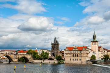 Beautiful view from the river Vltava on the Bank of Prague on a Sunny day with a dramatic sky.