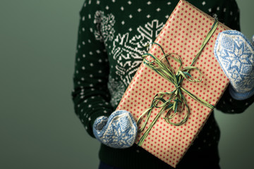 A girl holding a box with a Christmas present