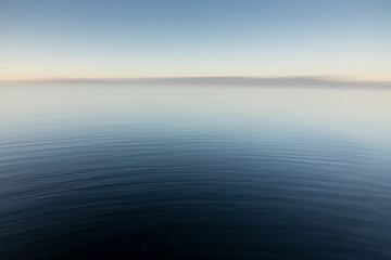 Abstract image of smooth ripples emanating across a body of water