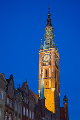 Fototapeta na wymiar View of the Main Town Hall's lit tower in Gdansk, Poland, in the evening. It's located at Long Market Street (Long Lane) in the Main Town (Old Town).