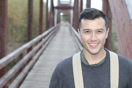 Handsome ethnic outdoorsy man smiling close up