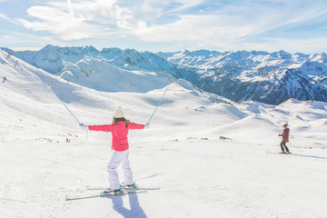 Fototapeta na wymiar Young woman skier enjoying a sunny day in the snow