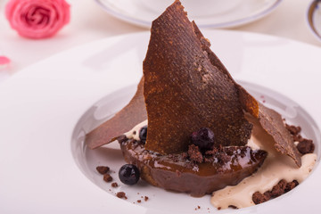 A dessert a caramel pudding with salty caramel and ice cream
