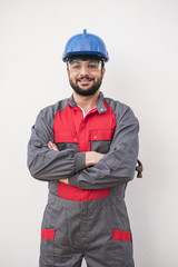 Worker posing in white wall background looking at camera