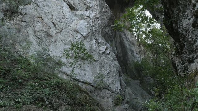 Wild nature of Eastern Serbia slow tilt footage - Natural stone bridge arch 