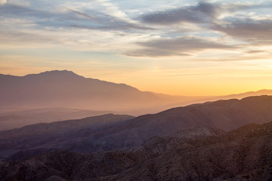 Fototapeta Colorful sky above a desert mountain landscape scene in California