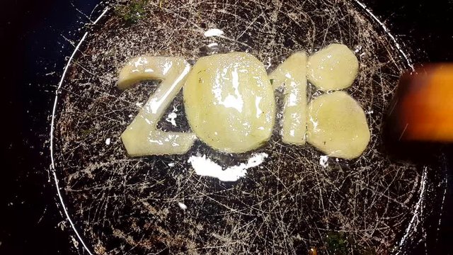 fry potatoes in a frying pan in the form of number 2018