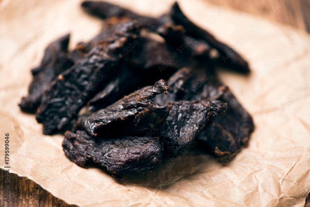 Wall mural Smoked beef jerky on on a table