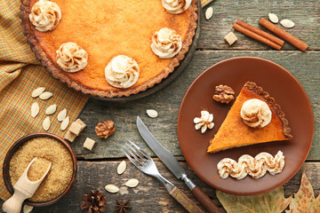 Sweet piece of pumpkin tart in plate on wooden table