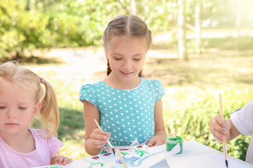 Children painting outdoors