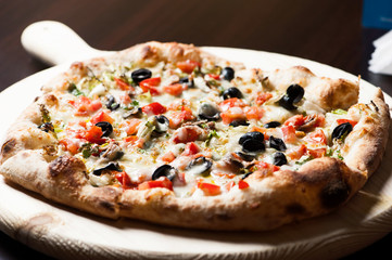 Delicious Pizza with a lot of ingridients baked in the oven