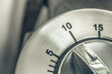 10 Minutes - Macro Of An Analog Chrome Kitchen Timer On Wooden Table