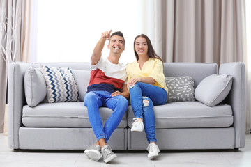 Young couple on sofa at home