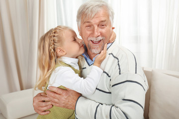 Elderly man with granddaughter at home
