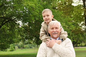 Elderly man with grandson in park