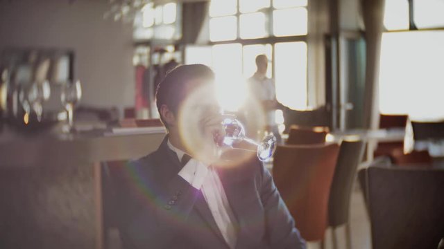 Confident man waiting for somebody in restaurant