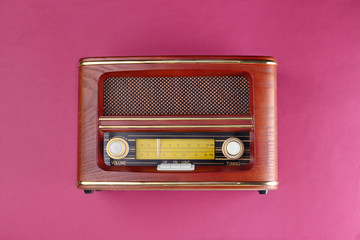 Retro radio on color background