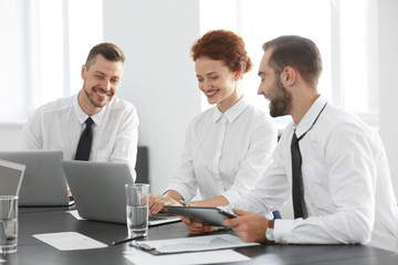 Team of young professionals conducting business meeting in office