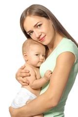 Happy young woman with cute baby on white background