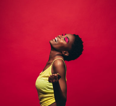 Cheerful Young Woman Dancing In Studio