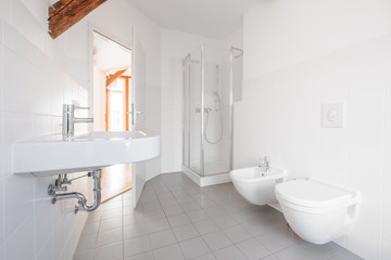 Fototapeta na wymiar modern bathroom - white tiled bath with shower