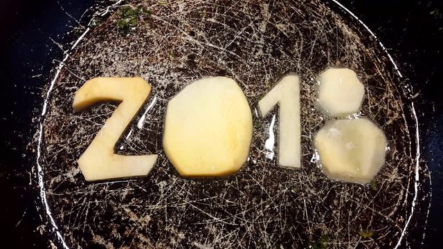 fry potatoes in a frying pan in the form of number 2018